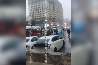 Yasamalda sakinlər avtobusları yağışın altında gözləyirlər